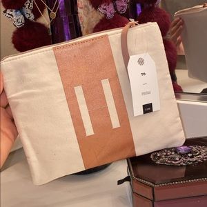 Fabric clutch or makeup bag.